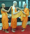 The monks dress Alan in his new Buddhist robes